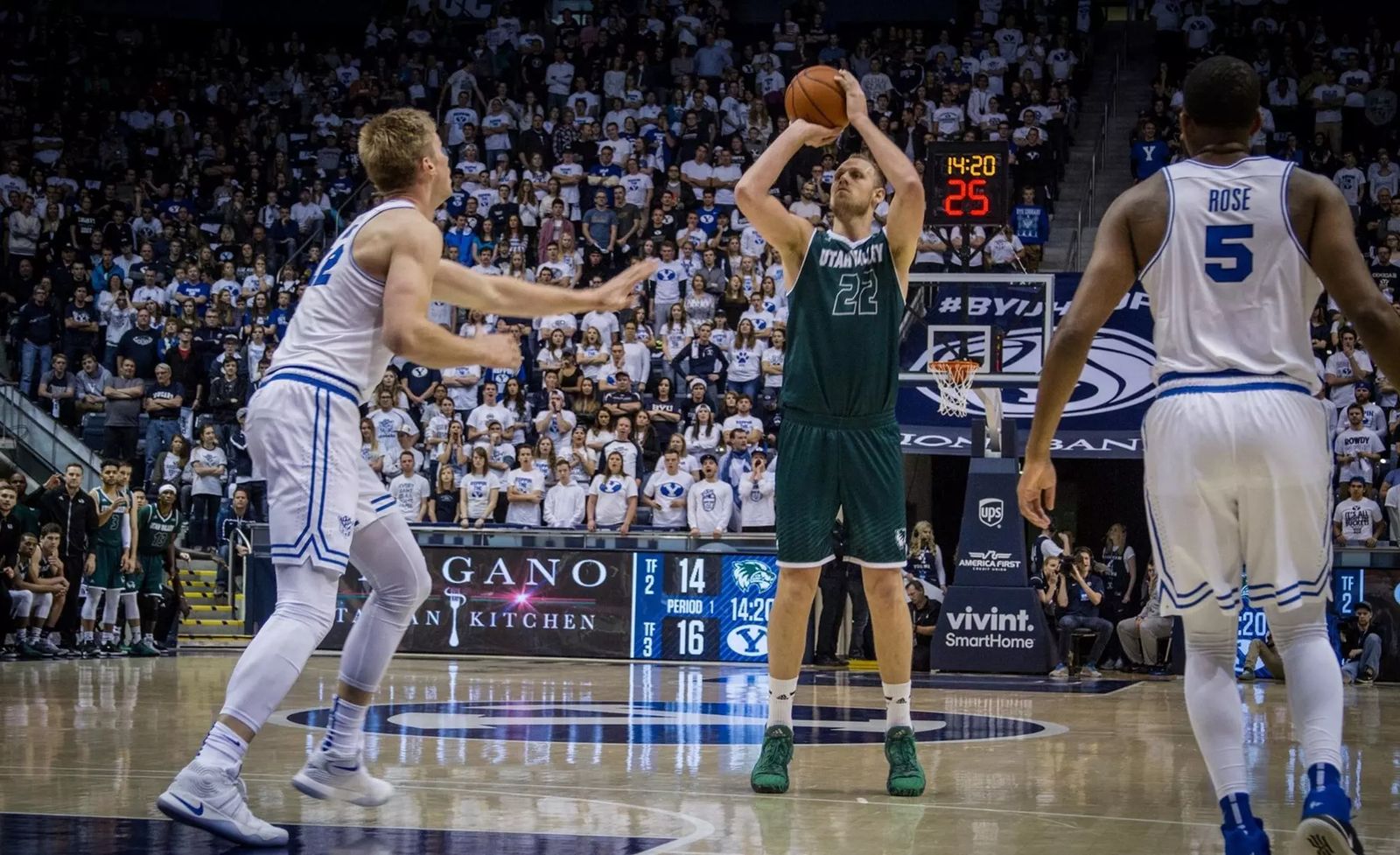 Isaac Neilson, number 22 for Utah Valley, shooting over a BYU defender at the Marriott Center